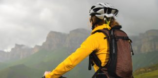 Co jest istotne przy wyborze dobrego plecaka sportowego? kobieta z lekkim plecakiem na rowerze w górach