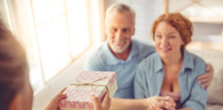 Praktyczny prezent na dzień babci i dziadka dziadkowie przyjmujący prezent od wnuczki